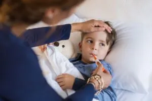 sick child having temperature taken