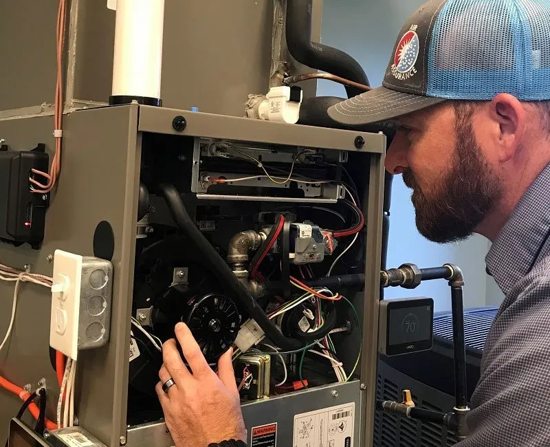 furnace technician performing heating repair