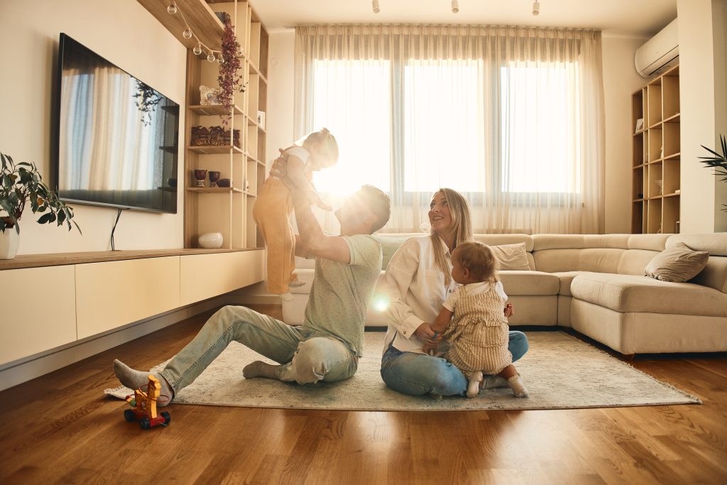 family playing on the floor of their well insulated home